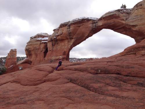 Erin Alberty  |  The Salt Lake Tribune

A hiker takes a rest at Broken Arch in Arches National Park.