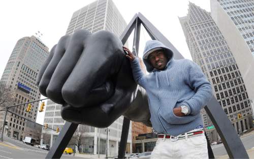 In a photo from March 28, 2016, Robert Wilcoxson stands next to The Monument to Joe Louis in Detroit. Wilcoxson is one of two people freed by the North Carolina Innocence Inquiry Commission, and he received $5 million in compensation. (AP Photo/Jose Juarez)