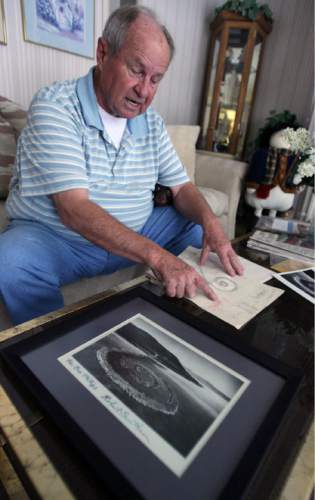 Steve Griffin  |  The Salt Lake Tribune
 
In this 2011 file photo, Bob Phillips looks over photos and original designs for the Spiral Jetty.  Phillips was the contractor who built the Spiral Jetty for artist Robert Smithson.