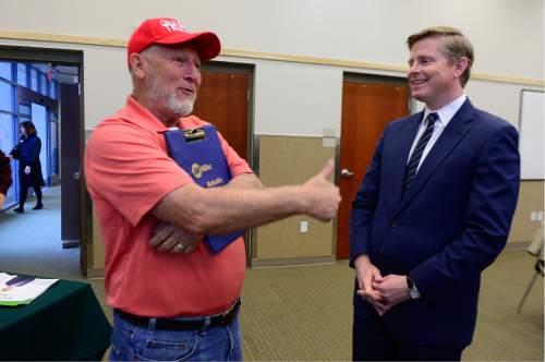 Scott Sommerdorf   |  The Salt Lake Tribune  
GOP gubernatorial candidate Jonathan Johnson, right,  speaks with Pete Olson of West Valley City prior to holding a meeting with state convention delegates in the Magna library, Thursday, April 14, 2016.