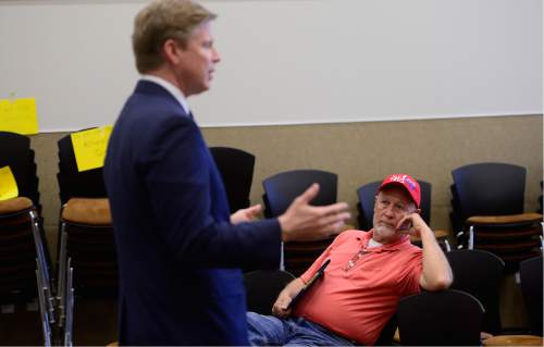 Scott Sommerdorf   |  The Salt Lake Tribune  
Pete Olson of West Valley City, right, listens as GOP gubernatorial candidate Jonathan Johnson answers questions at a meeting with state convention delegates in the Magna library, Thursday, April 14, 2016.