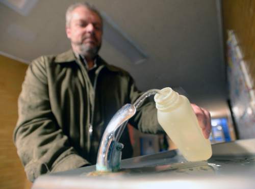 Al Hartmann  |  The Salt Lake Tribune 
Kevin Ray, risk management coordinator for Canyon School District takes early morning water sample from one of hallway drinking fountains at Edgemont Elementary School early in the morning Wed. March 30 before students arrive.  
The most common cause of lead poisoning is old corroded pipes that are basically rusting metals into the water. Lead pipes are now banned in the US, but at least 58 percent of Utah's schools were built before that law went into effect. In 1988, congress passed a law charging schools with identifying and rectifying lead contamination and pipe corrosion, but according to the EPA this law is essential impossible to enforce and is not widely implemented.
