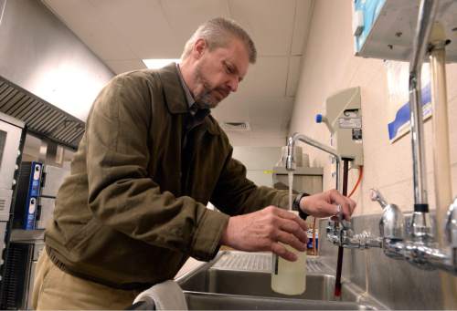 Al Hartmann  |  The Salt Lake Tribune 
Kevin Ray, risk management coordinator for Canyon School District takes early morning water samples from the Edgemont Elementary school's cafeteria early in the morning Wed. March 30 before students arrive.  
The most common cause of lead poisoning is old corroded pipes that are basically rusting metals into the water. Lead pipes are now banned in the US, but at least 58 percent of Utah's schools were built before that law went into effect. In 1988, congress passed a law charging schools with identifying and rectifying lead contamination and pipe corrosion, but according to the EPA this law is essential impossible to enforce and is not widely implemented.