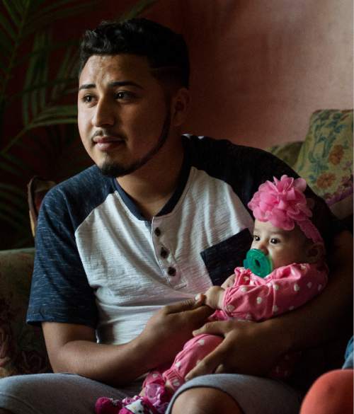 Steve Griffin  |  The Salt Lake Tribune


Granger High School soccer player Carlos Tavares holds he and his girlfriend, Marilin Marin's, daughter Abigail, in their current home with Marilin's  parents in West Valley City, talk about their young life together Wednesday, April 6, 2016.