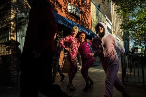 Chris Detrick  |  The Salt Lake Tribune
Revelers walk down Main Street during the Onesie Pub Crawl in Salt Lake City on Friday, April 15, 2016. The group was collecting donations to give to Youth Making A Difference Foundation while visiting several local bars in downtown Salt Lake City wearing onesie costumes.
