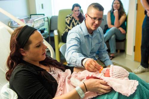 Chris Detrick  |  The Salt Lake Tribune
Paige Clark holds her daughter, Bexleigh, with her husband, Unified Police officer Travis Clark, at Intermountain Healthcare's Riverton hospital Tuesday April 19, 2016. UPD Lt. Lex Bell said the 6-pound, 7-ounce, 18.5-inch infant, first name "Bexleigh," arrived at 3:28 a.m. near the Salt Lake County-Utah County line.