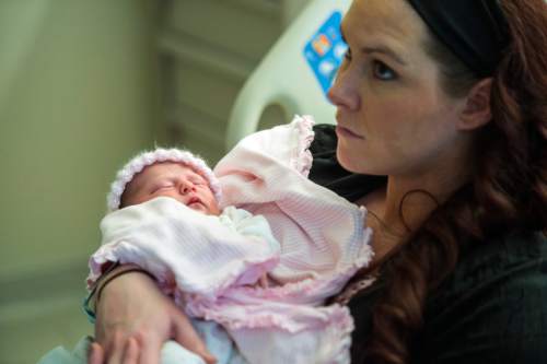 Chris Detrick  |  The Salt Lake Tribune
Paige Clark holds her daughter, Bexleigh, with her husband, Unified Police officer Travis Clark, at Intermountain Healthcare's Riverton hospital Tuesday April 19, 2016. UPD Lt. Lex Bell said the 6-pound, 7-ounce, 18.5-inch infant, first name "Bexleigh," arrived at 3:28 a.m. near the Salt Lake County-Utah County line.