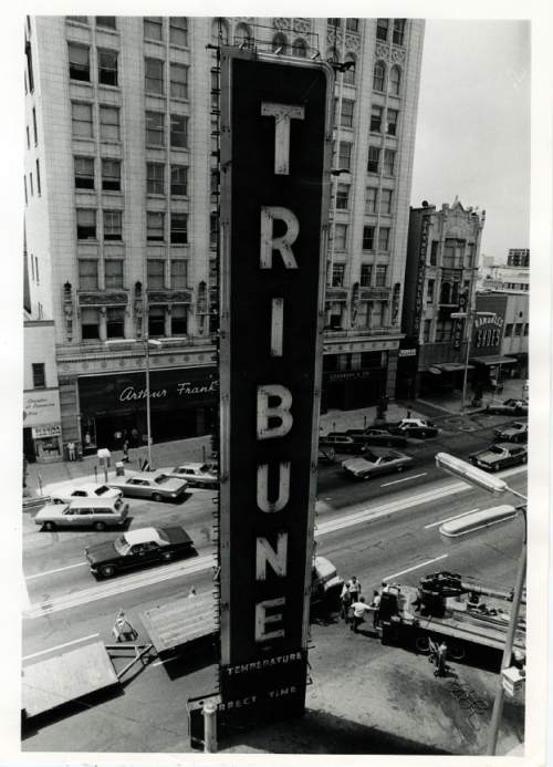 Tribune file photo

The Tribune sign is removed from the Main Street office in 1970.