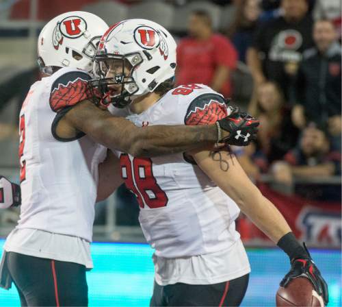 Rick Egan  |  The Salt Lake Tribune

 Utah Utes wide receiver Kenneth Scott (2) congratulates tight end Harrison Handley (88) celebrates after scoring a touchdown,  giving the Utes a 24-20 lead early in the second half,  in PAC-12 action against the Arizona Wildcats, in Tucson, Saturday, November 14, 2015.