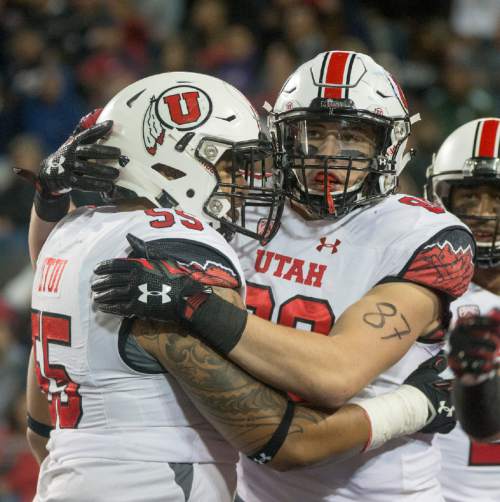 Rick Egan  |  The Salt Lake Tribune

Utah Utes offensive lineman Hiva Lutui (55), congratulates tight end Harrison Handley (88) celebrates after scoring a touchdown,  giving the Utes a 24-20 lead early in the second half,  in PAC-12 action against the Arizona Wildcats, in Tucson, Saturday, November 14, 2015.