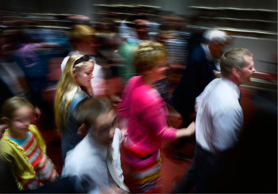 Scott Sommerdorf   |  The Salt Lake Tribune  
A young girl follows her family arm in arm as they exit the morning session of the 186th annual General Conference of the LDS Church, Sunday, April 3, 2016.