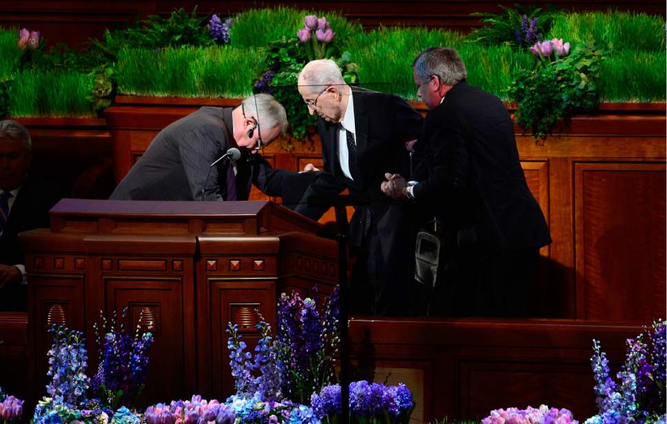 Scott Sommerdorf   |  The Salt Lake Tribune  
Elder Ropbert D. Hales is helped to his place at the podium for his talk to begin the afternoon session of the 186th annual General Conference of the LDS Church, Sunday, April 3, 2016.