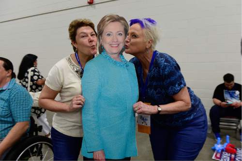Scott Sommerdorf   |  The Salt Lake Tribune  
Holly Miller, left, and Pauline Banks, right playfully kiss a life-size cardboard cutout of Democratic Presidential candidate Hillary Clinton at the Democratic state Convention where delegates voted on nominees for governor, congressional and other offices, Saturday, April 23, 2016