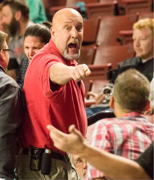 Rick Egan  |  The Salt Lake Tribune

An usher tries to calm down some unruly Utah Grizzlie fans, in ECHL playoff hockey action at the Maverik Center ,Sunday, April 24, 2016.
