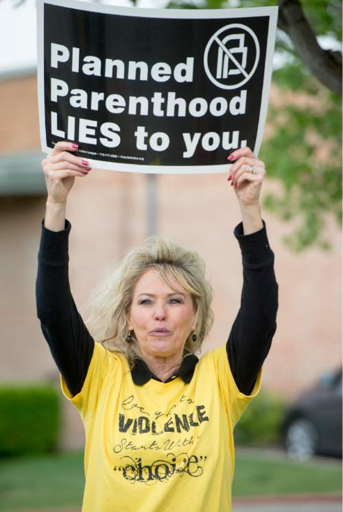 Rick Egan  |  The Salt Lake Tribune
Mary Taylor, President of Pro Life Utah, holds up a sign during a pro-life protest outside Planned Parenthood in Salt Lake on Saturday.