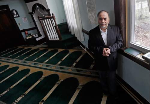 In this April 12, 2016 photo, Amjad Bhatti, president of the Islamic Society of Greater Worcester, poses inside the mosque in Worcester, Mass. He and other leaders of the mosque are hoping to build a Muslim cemetery on farmland in Dudley, Mass., but residents are vigorously opposing the project. (AP Photo/Elise Amendola)