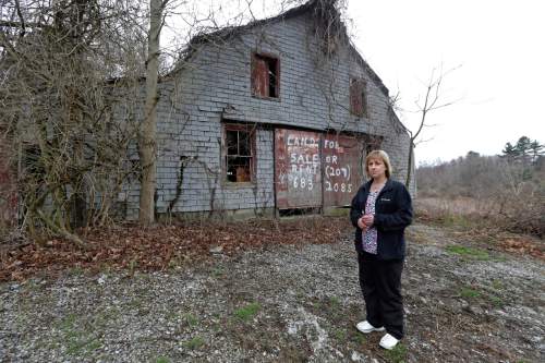 In this April 12, 2016 photo, Desiree Moninski, stands on land located across from her house in Dudley, Mass., which is the site of a proposed Muslim cemetery, a project vigorously opposed by area residents. Regarding the land once farmed by her grandparents, Moninski said she and other opponents have legitimate concerns that have nothing to do with Islam. "I grew up here. It's farmland, and I'd like to see it stay that way," she said. (AP Photo/Elise Amendola)
