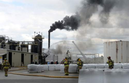 Al Hartmann  |  The Salt Lake Tribune
Firefighters battle a smoky fire from an asphalt container at an industrial refinery at 2600 S. 1600 W. in Woods Cross Tuesday April 26.