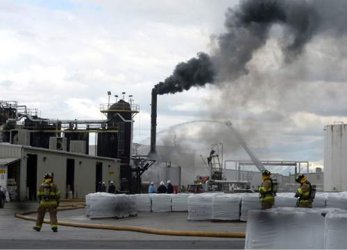 Al Hartmann  |  The Salt Lake Tribune
Firefighters battle a smoky fire from an asphalt container at an industrial refinery at 2600 S. 1600 W. in Woods Cross Tuesday April 26.