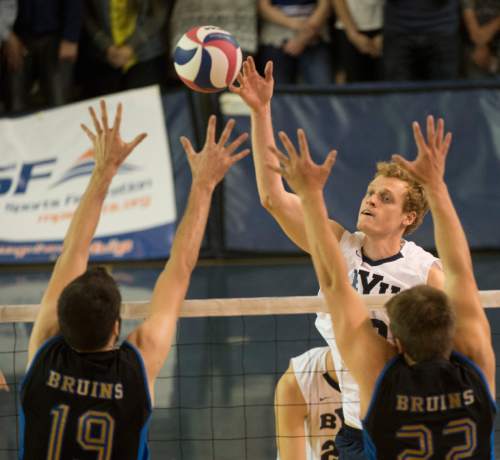 Rick Egan  |  The Salt Lake Tribune

Brigham Young Cougars Jake Langlois (10) hits the ball over the hands of UCLA Bruins Eric Sprague (19) and UCLA Bruins Hagen Smith (22), in BYU's victory in the Mountain Pacific Sports Federation Volleyball Championship game,  in tournament action at the Smith Field House in Provo, Saturday, April 23, 2016.