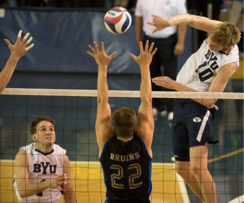 Rick Egan  |  The Salt Lake Tribune

Brigham Young Cougars Jake Langlois (10) hits the ball past UCLA Bruins Hagen Smith (22) as Brigham Young Cougars Price Jarman (1) looks on, in BYU's victory in the Mountain Pacific Sports Federation Volleyball Championship game,  in tournament action at the Smith Field House in Provo, Saturday, April 23, 2016.