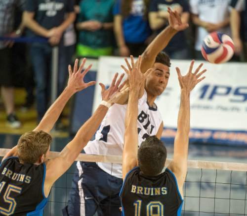 Rick Egan  |  The Salt Lake Tribune

Brigham Young Cougars Ben Patch (13) hits the ball past UCLA Bruins Jake Arnitz (15) and UCLA Bruins Eric Sprague (19), in the Mountain Pacific Sports Federation Volleyball Championship game, in tournament action at the Smith Field House in Provo, Saturday, April 23, 2016.