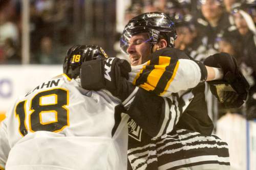 Rick Egan  |  The Salt Lake Tribune

Colorado Eagles defender Teigan Zahn (18) gets tangled with Utah Grizzlies forward  Bryan Moore (14), in ECHL playoff hockey action at the Maverik Center ,Sunday, April 24, 2016.