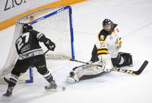 Rick Egan  |  The Salt Lake Tribune

Colorado Eagles goalie Clarke Saunders (33) deflects a shot by Utah Grizzlies forward  Alex Krushelnyski (27), in ECHL playoff hockey action at the Maverik Center ,Sunday, April 24, 2016.