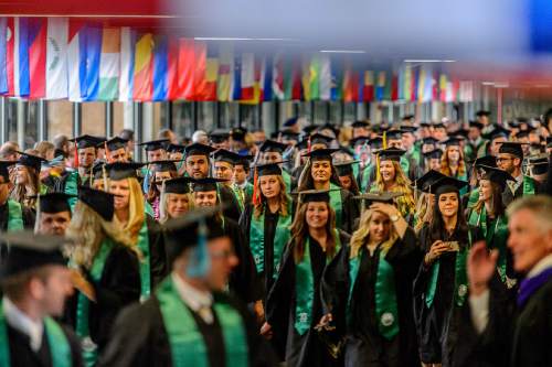 Trent Nelson  |  The Salt Lake Tribune
Utah Valley University graduates walk through the school's Hall of Flags at the beginning of Commencement, in Orem, Thursday April 28, 2016. UVU awarded 5,409 degrees at its historic 75th Commencement.