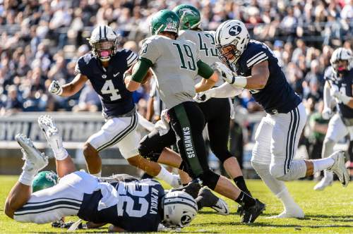 Trent Nelson  |  The Salt Lake Tribune
Brigham Young Cougars defensive lineman Bronson Kaufusi (90) sacks Wagner Seahawks quarterback Alex Thomson (19) as BYU hosts Wagner, NCAA football at LaVell Edwards Stadium in Provo, Saturday October 24, 2015.