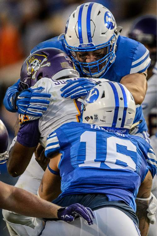 Trent Nelson  |  The Salt Lake Tribune
Brigham Young Cougars defensive lineman Bronson Kaufusi (90) brings down East Carolina Quarterback Cody Keith as BYU hosts East Carolina, college football at LaVell Edwards Stadium in Provo, Saturday October 10, 2015.