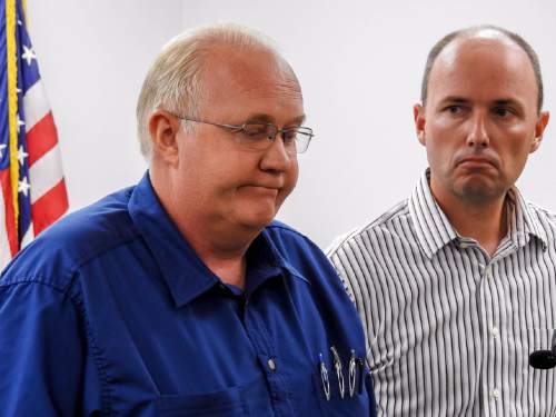 Trent Nelson  |  The Salt Lake Tribune
Hildale Mayor Phillip Barlow, left, speaks with Utah Lt. Governor Spencer Cox at right, after nine people were killed and five remained missing Tuesday morning, the day after an SUV and a van were washed off a road during a flash flood in this polygamous Utah-Arizona border community.