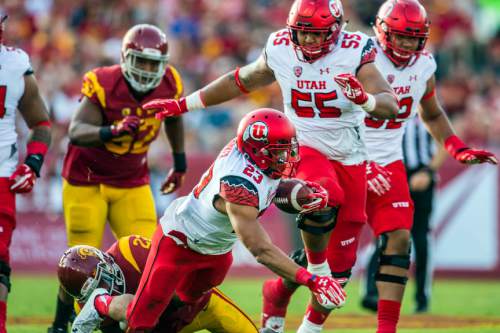 Chris Detrick  |  The Salt Lake Tribune
Utah Utes running back Devontae Booker (23) is tackled by USC Trojans safety Leon McQuay III (22) during the game at the Los Angeles Memorial Coliseum Saturday October 24, 2015.