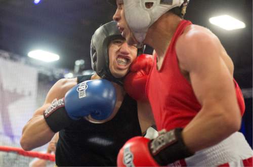 Rick Egan  |  The Salt Lake Tribune

Onero Gallegos, Idaho (red) fights Gabriel Chairez, Utah (blue) in the 132 weight class, in the Golden Gloves Boxing Rocky Mountain Regionals, at the South Towne Expo Center in Sandy, Saturday, April 30, 2016.
