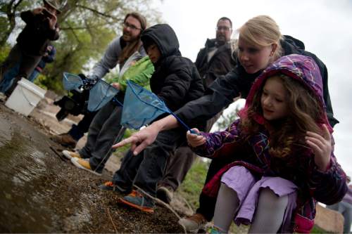 Lennie Mahler  |  The Salt Lake Tribune

DaVinci Academy Principal Erika Kortman and kindergarten student Gracie watch as they release trout into the Ogden River on Friday, April 29, 2016. Eleanor Sather helped her class hatch and raise trout delivered by the DWR and Trout Unlimited in January.