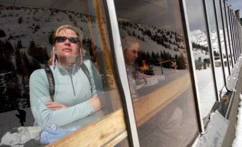 Francisco Kjolseth  |  The Salt Lake Tribune

Mountains and skiers are reflected as Bonnie Rosenthall of New Jersey keeps an eye out for the rest of her party alongside her daughter Alexa from within the cozy confines of Watson's Shelter, mid-mountain at Alta on April 11, 2005. The popular Collins Grill and Watson's Cafeteria housed within serves its last customers before it is torn down soon and replaced with a new building nearby.