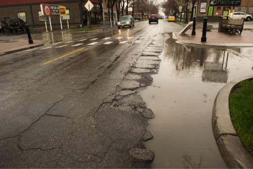 Rick Egan  |  The Salt Lake Tribune
Potholes mar the street on 1100 East between Hollywood Ave and 2100 South. A so-called "prison sales tax" has been put forward as a possible source to get funds for repairs.