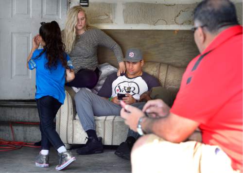 Scott Sommerdorf   |  The Salt Lake Tribune  
Utah DE Jason Fanaika's wife Brittney gives him some support as he keeps in touch with his agent and the progress of the NFL draft while waiting for his name to be called during the NFL draft at the house of his father, Sefita Fanaika, Saturday, April 30, 2016.