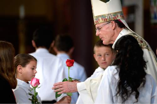 Scott Sommerdorf   |  The Salt Lake Tribune
Archbishop John Wester accepts roses from children as he presides over his final Mass at the Cathedral of the Madeleine, Sunday, May 31, 2015. Wester has been bishop of the Salt Lake City diocese and its 300,000 Catholics since March 2007, and is to be installed as archbishop of the Sante Fe diocese on Thursday (June 4).
