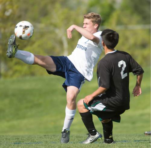 Rick Egan  |  The Salt Lake Tribune

Isaac Bruce (8) Waterford, kicks the ball, as Joe Rivera (2) defends for Wendover, in prep soccer action in Sandy, Wednesday, May 4, 2016.