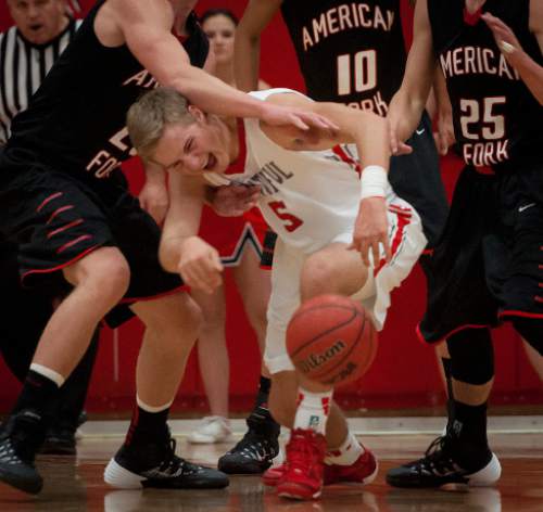 Michael Mangum  |  Special to the Salt Lake Tribune

Bountiful Braves senior Sam Merrill (5) loses the ball with heavy pressure from American Fork Cavemen defenders during the second half of play at Bountiful High School in Bountiful, UT on Friday, December 13, 2013.