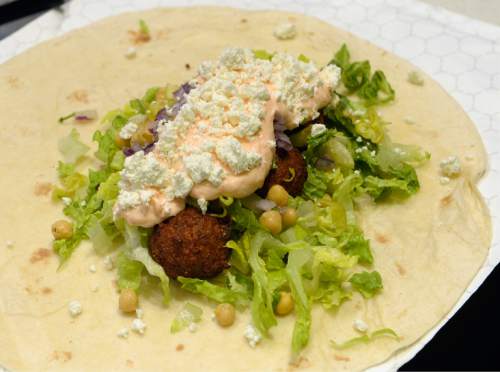 Al Hartmann  |  The Salt Lake Tribune
Falafel bomb wrap, this one made to order with lettuce, garbonzo beans and feta cheese at Padeliís Street Greek, a fast-casual restaurant in Salt Lake City that makes gyros and more to order. Falafel bomb can also be made as a gyro.
