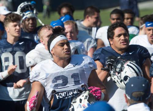 Rick Egan  |  The Salt Lake Tribune

Linebacker, Harvey Langi (21) sings the BYU Fight Song along with the team after BYU's final practice of spring camp, at LaVell Edwards Stadium, Friday, April 1, 2016.