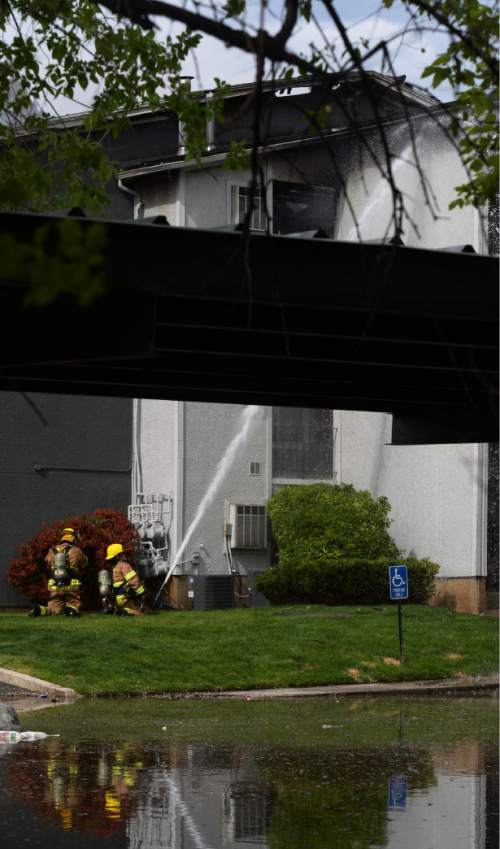 Steve Griffin  |  The Salt Lake Tribune
Fire fighters spray water on a hot spot of a large apartment fire near 500 east and 4100 south in Salt Lake City on Thursday.