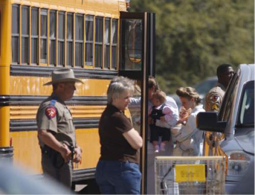 Trent Nelson  |  The Salt Lake Tribune

FLDS women and children from the YFZ ranch are escorted by Texas Child Protective Services workers and Schleicher County Sheriff's deputies from the First Baptist Church's Fellowship Hall to buses in this April 2008 photo.