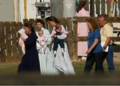 Chris Detrick  |  The Salt Lake Tribune

FLDS women and children walk outside at Fort Concho in San Angelo, Texas, on April 11, 2008, where they are being housed temporarily.Children removed from a polygamous sect's Texas ranch will remain in facilities here until a scheduled April 17 hearing on their status, officials said Friday. The 416 children from the YFZ Ranch, accompanied by 139 women, are staying at the Wells Fargo Pavilion and historic Fort Concho.