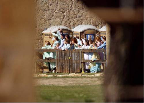 Trent Nelson  |  The Salt Lake Tribune

FLDS women stand behind a fence at Fort Concho, waving to other FLDS women in another building. Texas Child Protective Services said they have taken 401 children from the YFZ Ranch into protective custody as of Monday, April 7, 2008 and brought them to Fort Concho.