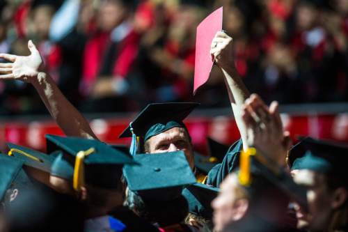 Chris Detrick  |  The Salt Lake Tribune
University of Utah graduates wave to family members during the annual Commencement at the Huntsman Center Thursday May 5, 2016.