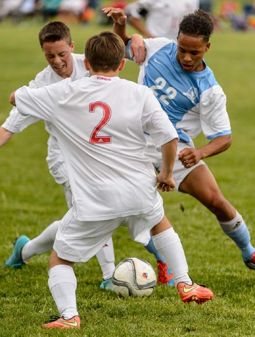 Trent Nelson  |  The Salt Lake Tribune
Grantsville's Brock May and Tyson Tuckett (2) fight for the ball with Ben Lomond's Deontay Nish in the first round of the boys' high school soccer Class 3A postseason, Thursday May 5, 2016.