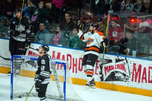 Chris Detrick  |  The Salt Lake Tribune
Komets' Garrett Thompson (48) celebrates his goal past Grizzlies' Eric Knodel (6) and Grizzlies' Marc Cantin (12) during Game 4 of the ECHL playoff series at Maverik Center Friday May 6, 2016.
